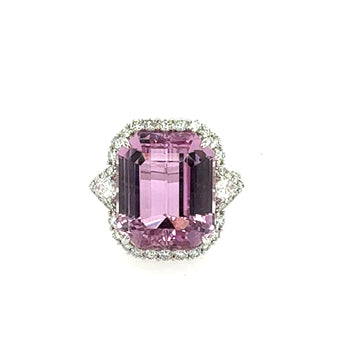 Pink gemstone ring with a white gemstone band on a white background