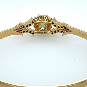 Close-up view of vivid emerald and diamond setting – handmade luxury bangle from New Orleans jeweler HGM