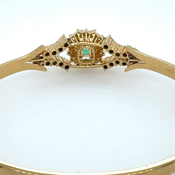 Close-up view of vivid emerald and diamond setting – handmade luxury bangle from New Orleans jeweler HGM