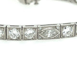 Side view of vintage diamond tennis bracelet with platinum setting and geometric Art Deco details