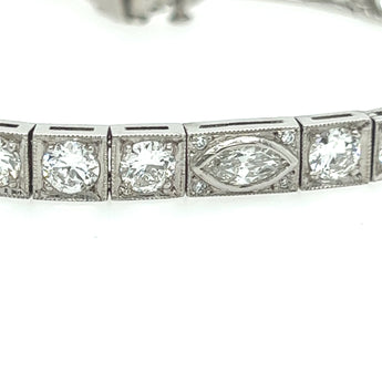 Side view of vintage diamond tennis bracelet with platinum setting and geometric Art Deco details