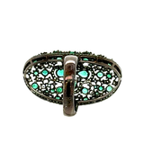 Model wearing elongated emerald cocktail ring – Luxury jewelry New Orleans