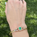 Emerald and diamond bracelet worn on wrist outdoors – handmade New Orleans bracelet from HGM Jewelry