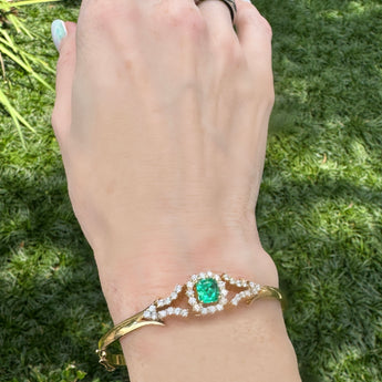 Emerald and diamond bracelet worn on wrist outdoors – handmade New Orleans bracelet from HGM Jewelry