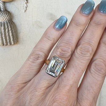 Emerald cut diamond ring on hand – custom New Orleans engagement ring