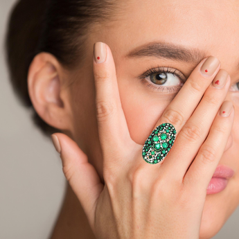 Close-up of emerald and diamond ring on hand – Statement jewelry New Orleans