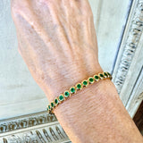 Emerald bracelet worn on wrist – handcrafted 18k yellow gold jewelry from New Orleans