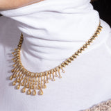 Diamond necklace with elegant curved drape in 18k gold – contemporary New Orleans fine jewelry