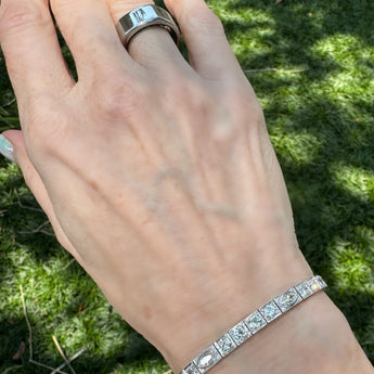 Flatlay image of Art Deco diamond line bracelet with round and marquise-cut diamonds set in platinum