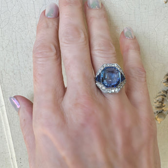 Model showcasing natural color blue sapphire and diamond ring – HGM Jewelry New Orleans