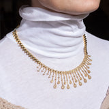 Close-up side detail of modern yellow gold necklace with diamond spacing – New Orleans fine jewelry collection