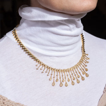 Close-up side detail of modern yellow gold necklace with diamond spacing – New Orleans fine jewelry collection