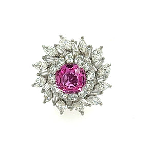 Front view of a pink sapphire ballerina ring in platinum, featuring a 2.45ct center stone with a halo of brilliant-cut, marquise, and baguette diamonds.