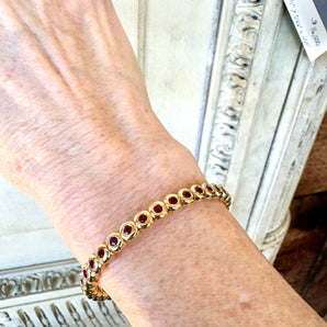 Ruby bracelet worn on wrist – elegant 18k yellow gold jewelry from HGM Jewelry New Orleans