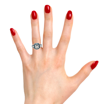 Elegant Art Deco emerald-cut diamond and sapphire ring on hand – New Orleans vintage engagement jewelry