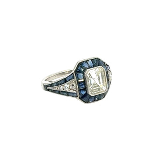 Side profile of vintage platinum ring with emerald-cut diamond and blue sapphires – New Orleans fine jewelry