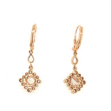 Detailed view of rose gold drop earrings with rose-cut diamonds, elegant handcrafted jewelry