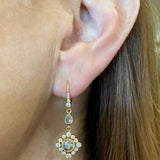 Diamond drop earrings in 18K rose gold worn on ear, New Orleans jewelry fashion style shot