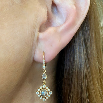 Diamond drop earrings in 18K rose gold worn on ear, New Orleans jewelry fashion style shot
